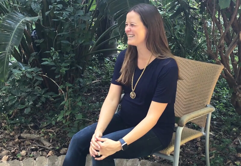Pregnant Antonia sitting in her garden 