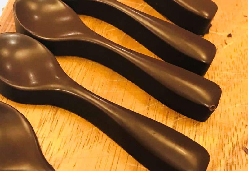 chocolate spoons on a bread board