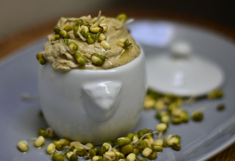 spicy bean hummus in white jug