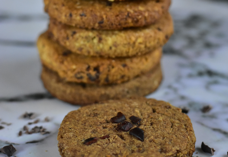 stacked cashew cookies on grey marble counter