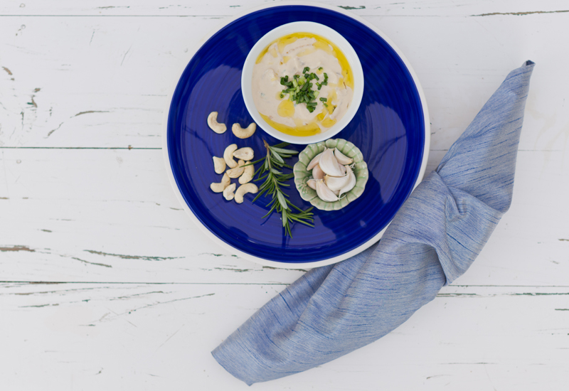 onion dip in a blue bowl with blue serviette